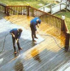Deck being pressure washed highlights the amount of dirt and grime on the deck surface
